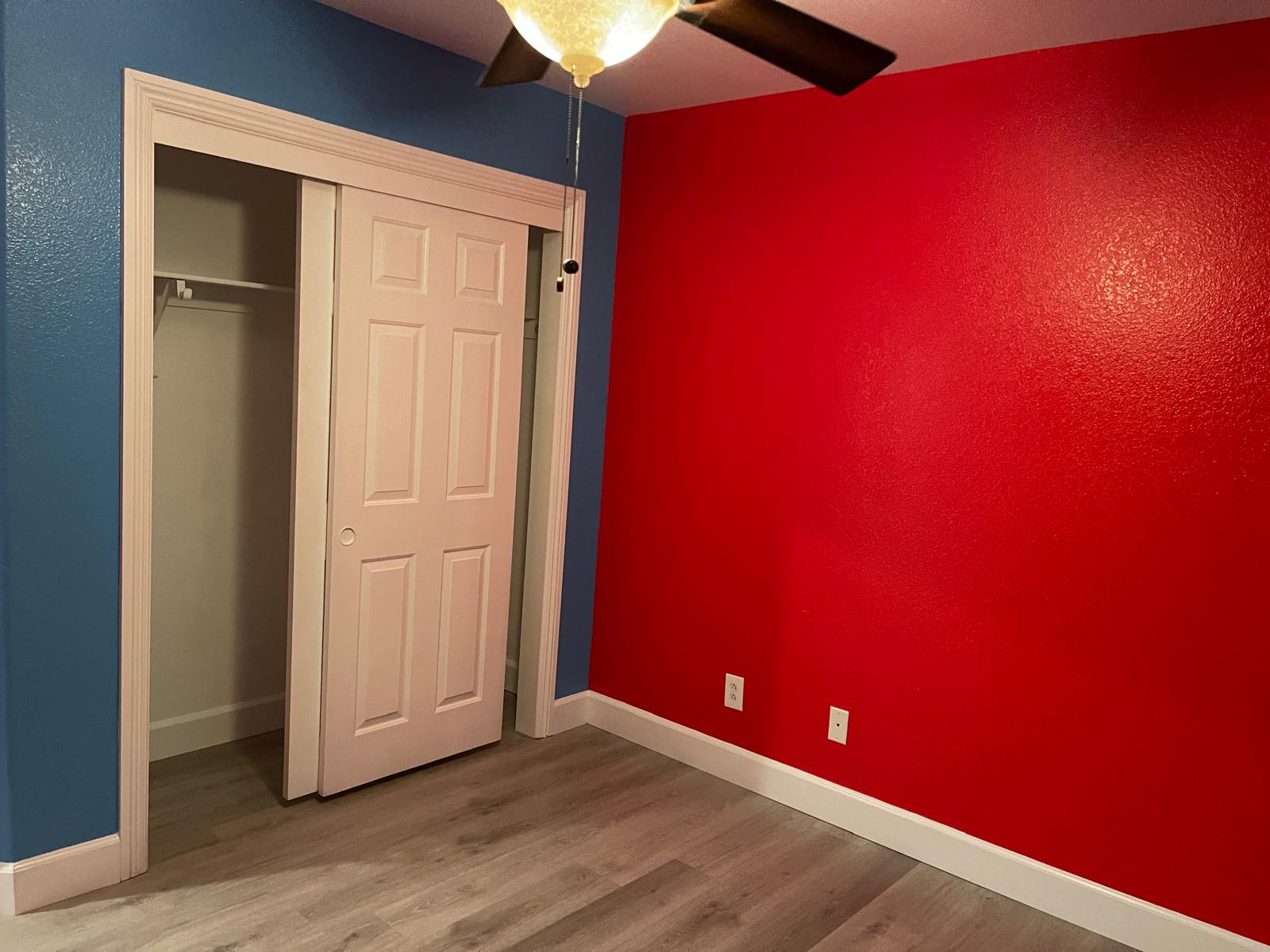Bedroom with bold red and blue accent walls