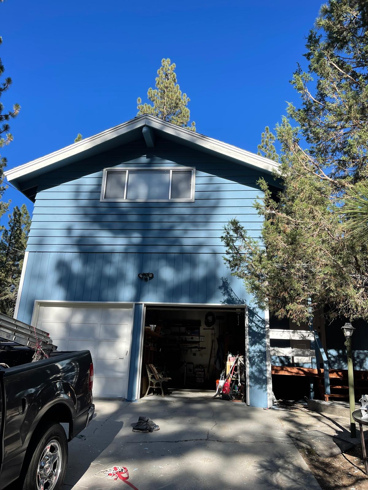 Home exterior after repaint, fresh blue and white finish